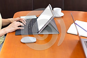 Woman hands typing on laptop keyboard working at home concept.