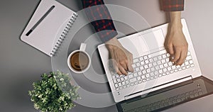woman hands typing on laptop keyboard. workplace desk. top view