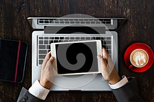 Woman hands typing laptop with office stuff with Movie clapper, laptop, smartphone, tablet, coffee cup, pen, notepad and documents