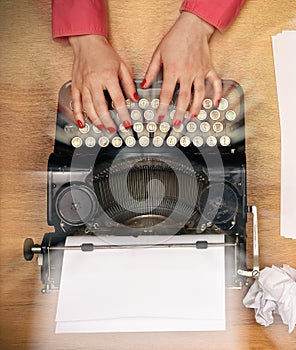 Woman hands typing on vintage typewriter