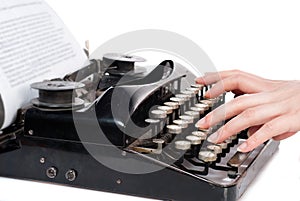 Woman hands typing on vintage typewriter isolated