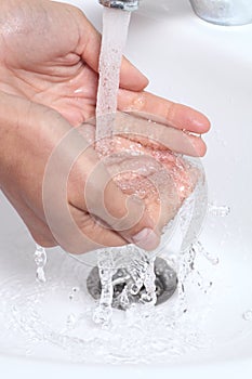 Woman hands under a waterjet