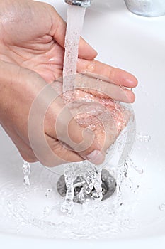 Woman hands under a waterjet photo