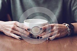 Woman hands with Ñup of coffee