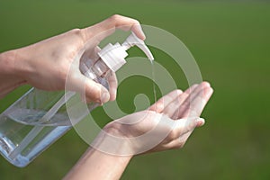 Woman hands using gel alcohol sanitizer cleaning her hands, to prevent the virus and bacterias, she protects herself and her