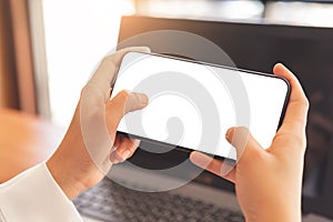 Woman hands using horizontal white screen smartphone mockup photo