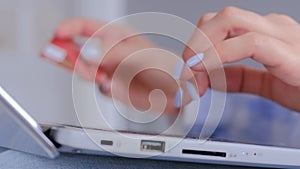Woman hands using laptop computer keyboard and credit card for online shopping
