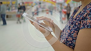Woman hands using mobile phone in Department store :