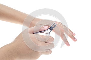 Woman hands using a nail clippers to cut her fingernails