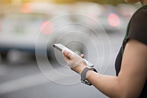 Woman hands using smartphone at city photo