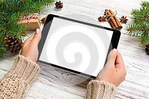 Woman hands using tablet computer on wooden table bachground. cristmas shopping time. Happy Christmas mock up background, top view