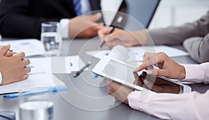 Woman hands using tablet at meeting. Business people group working together in office, close-up. Negotiation and