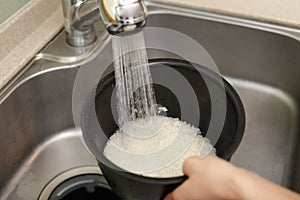 Woman hands washing rice