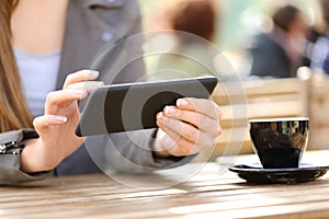 Woman hands watching videos on phone on a cafe terrace