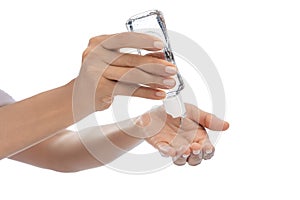 Woman hands, on White empty isolated background using hand sanitizer Small portable squeezable dispenser alcohol gel, coronavirus