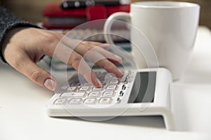 Woman hands working on calculator. Finances, economy, budgetand