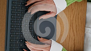 Woman hands working laptop in home office vertical closeup. Lady typing computer