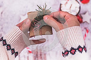 Woman hands wrap christmas holiday handmade present in craft paper