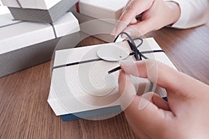 Woman hands wrapping gift box, unwrap or open present