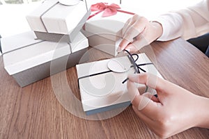 Woman hands wrapping gift box, unwrap or open present