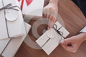 Woman hands wrapping gift box, unwrap or open present