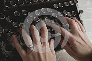 woman hands writing with an antique typewriter