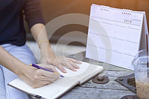 Woman hands writing plan on notebook, planning agenda and schedule using calendar event planner. Calender planner organization