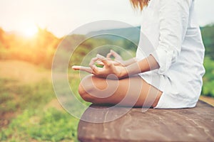 Woman hands yoga meditations and making a zen symbol with her ha photo