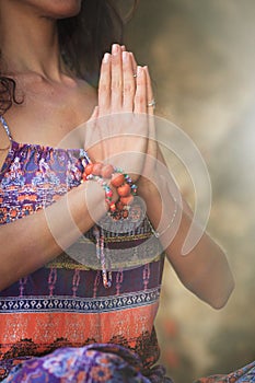 Woman hands in yoga symbolic gesture mudra namaste outdoor autu