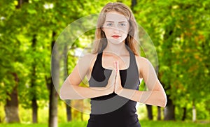 Woman hands in yoga symbolic gesture mudra namaste outdoor park closeup