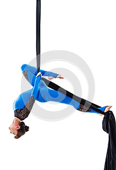 Woman hanging in aerial silk, isolated on white
