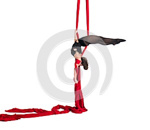 Woman hanging in aerial silks, isolated on white