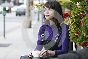 Woman Hanging Out And Having Coffee at Sidewalk Cafe