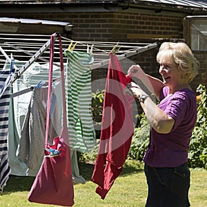 Woman hanging washing out to dry