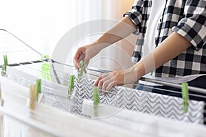 Woman hanging wet clothes to dry