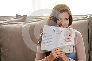 Woman, happiness and pregnancy book in living room for research, planning and portrait in house for baby. Learning