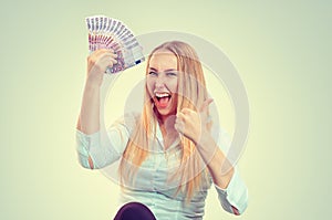 Woman happy holding money looking at you