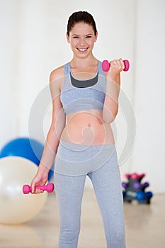 Woman, happy or portrait with dumbbell in gym for health wellness, fitness or weight loss with training. Young person