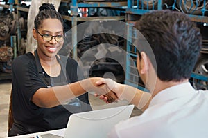 Woman happy and shakehand with man after deal succeed. Diversity of two people, caucasian business manager work with African photo