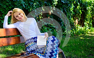 Woman happy smiling blonde take break relaxing in garden reading poetry. Lady enjoy poetry in garden. Enjoy rhyme. Girl