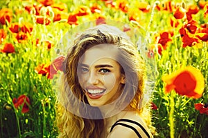 Pretty woman or happy girl in field of poppy seed