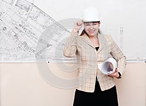 Woman in hard hat with blueprints