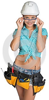 Woman in hard hat, tool belt and protective