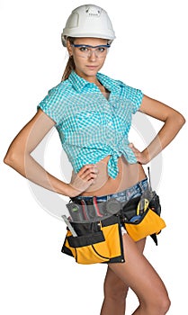 Woman in hard hat, tool belt and protective