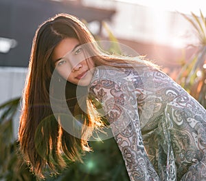 Woman with hard sunflare on with construction site on the background for developing city woman cocnept photo