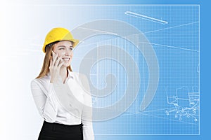 Woman in hardhat and blueprint