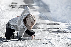 Woman has an accident cause of black ice on the road, downfall and injury