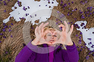 Woman has fun and enjoys saffron blooming at the mountains