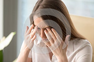 Woman has headache because of critical overwork