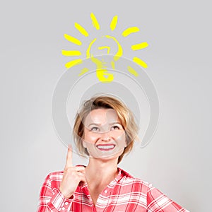 Woman has an idea, showing finger up on light bulb